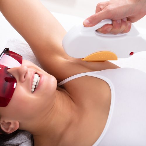 Beautiful Young Woman Having Underarm Laser Hair Removal Treatment In Spa